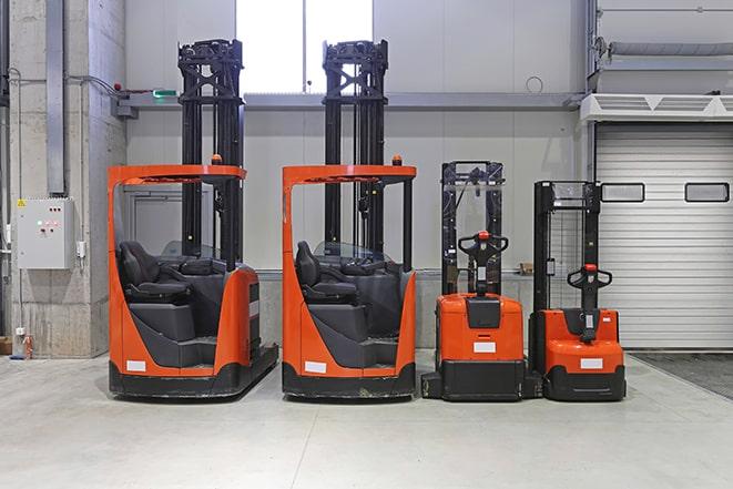 forklifts loading cargo onto a delivery truck